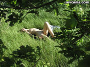 Spy on a nude girl sunbathing in a field - 12 voyeur Pictures